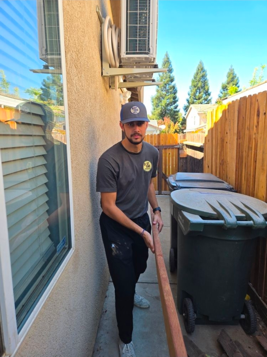 Bout Time Junk Removal crew providing fast, friendly junk removal service in Sacramento, hauling furniture and debris into a clean branded truck.